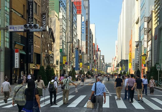 Shoppers walking down the middle of Chuo-dori during the Ginza weekend pedestrian paradise