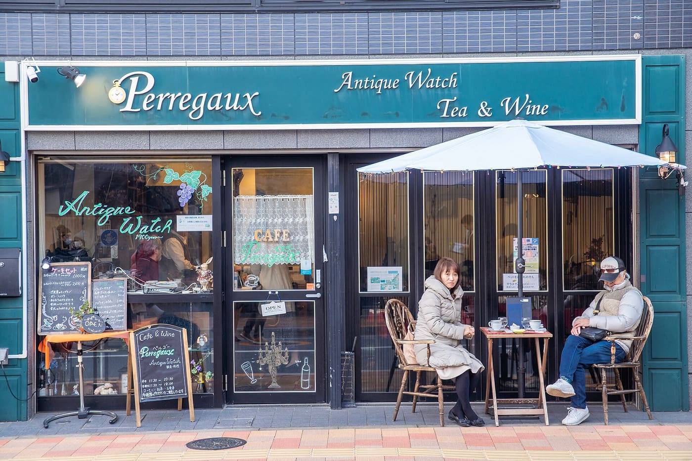 Couple at a French-style cafe terrace table on a Kagurazaka street