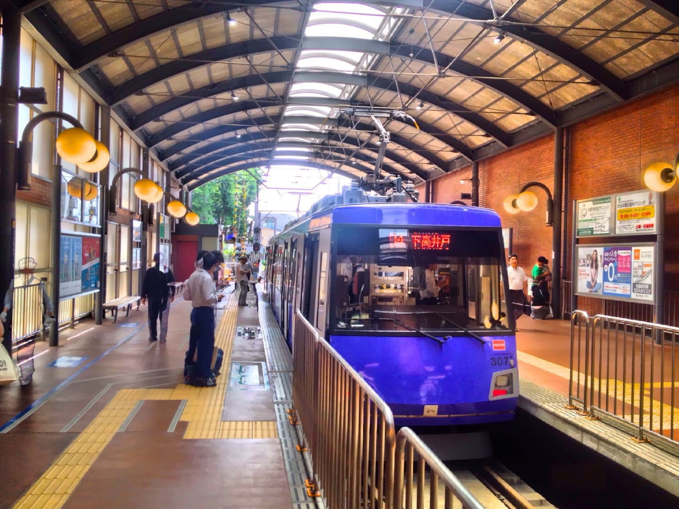 Tokyu Setagaya Line tram waiting under the arched roof of its Sangenjaya terminus