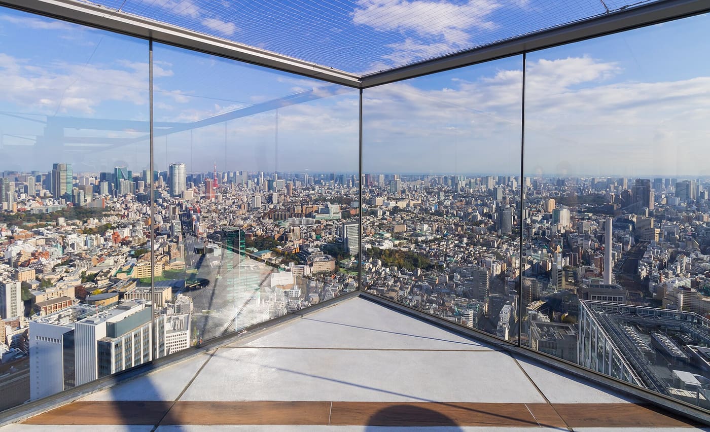 Glass corner of the Shibuya Sky rooftop deck looking out over Tokyo from 229 metres