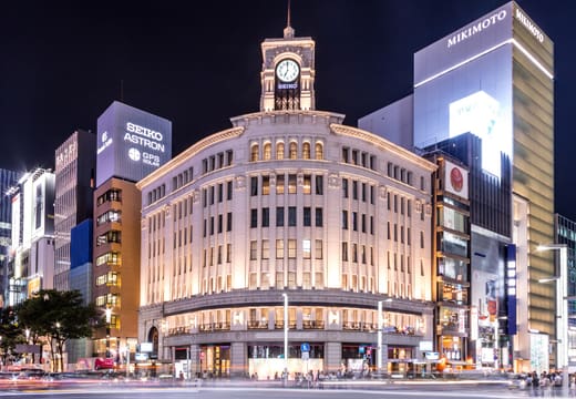 The Wako clock tower lit at night on the Ginza 4-chome crossing