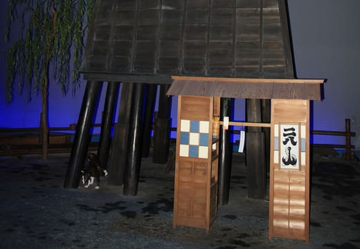 Recreated wooden fire watchtower in the dimmed Edo streetscape of the Fukagawa Edo Museum