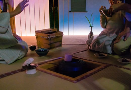 Tea ceremony at a sunken hearth in a tatami room during an evening at Happo-en