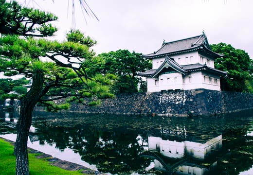 White Fujimi-yagura keep of the old Edo Castle mirrored in the moat