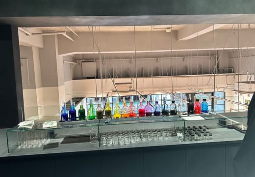 Rows of coloured ink bottles on the mixing counter of the ink stand at Kakimori, Kuramae