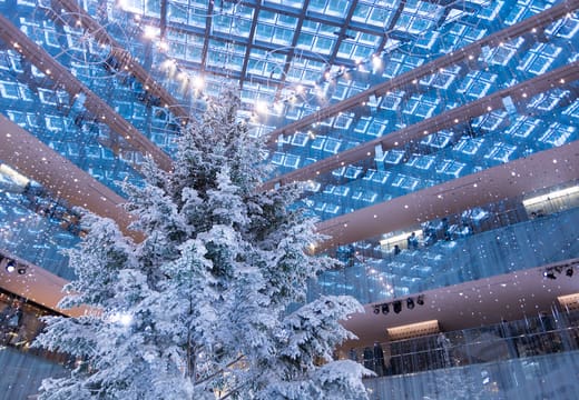 Giant white Christmas tree filling the atrium of KITTE Marunouchi
