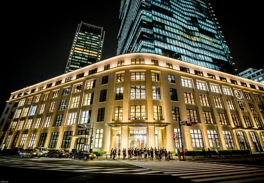 Restored facade of the former Tokyo Central Post Office housing KITTE, lit at night
