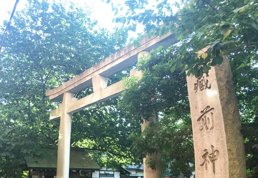 Side torii and carved stone name pillar at the entrance of Kuramae Shrine