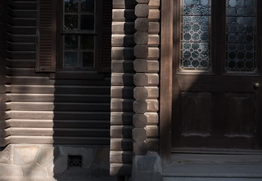 Log walls and stained glass door of the Swiss chalet billiard house at Kyu Iwasaki-tei