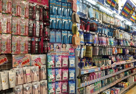Floor-to-ceiling displays of snacks and cosmetics in the aisles of MEGA Don Quijote Shibuya