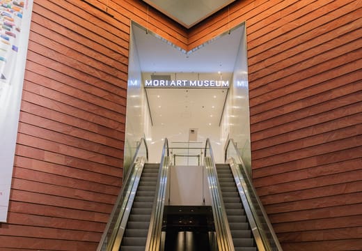 Escalators rising between wooden walls to the Mori Art Museum entrance in Roppongi Hills