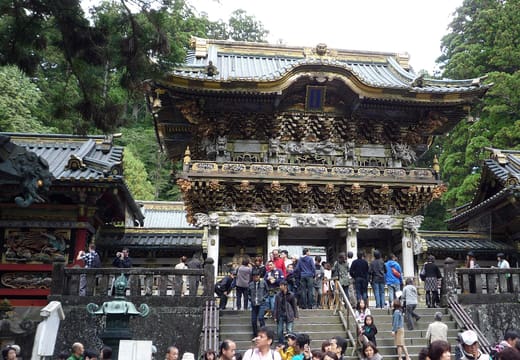 Visitors climbing the steps to the ornate Yomeimon gate of Nikko Toshogu