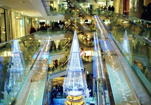 Spiral ramps and a glowing Christmas tree in the central atrium of Omotesando Hills