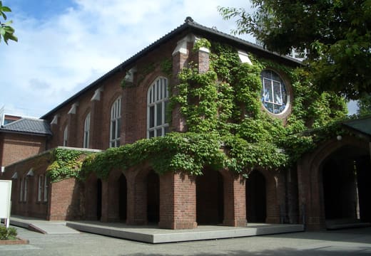 Red brick All Saints Chapel with arched porch on the Rikkyo University Ikebukuro campus