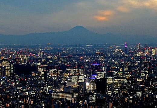 Mount Fuji on the horizon at dusk seen over the lights of Tokyo from Tokyo Skytree