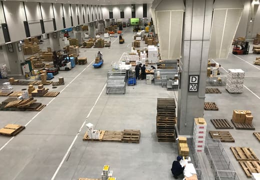 Wholesale floor of Toyosu Market seen from the visitor gallery with pallets and carts