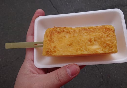 Slice of sweet tamagoyaki omelette on a stick from Yamacho at Tsukiji Outer Market