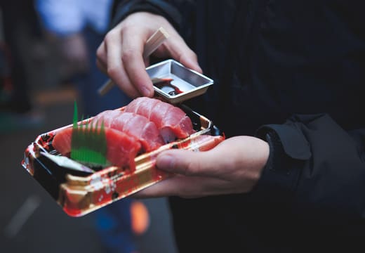 Tray of fresh tuna sashimi with soy sauce bought at Tsukiji Outer Market