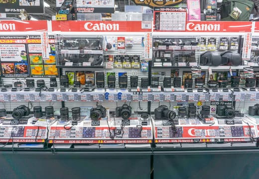 Rows of Canon cameras and lenses on the sales floor of Yodobashi Camera Akihabara
