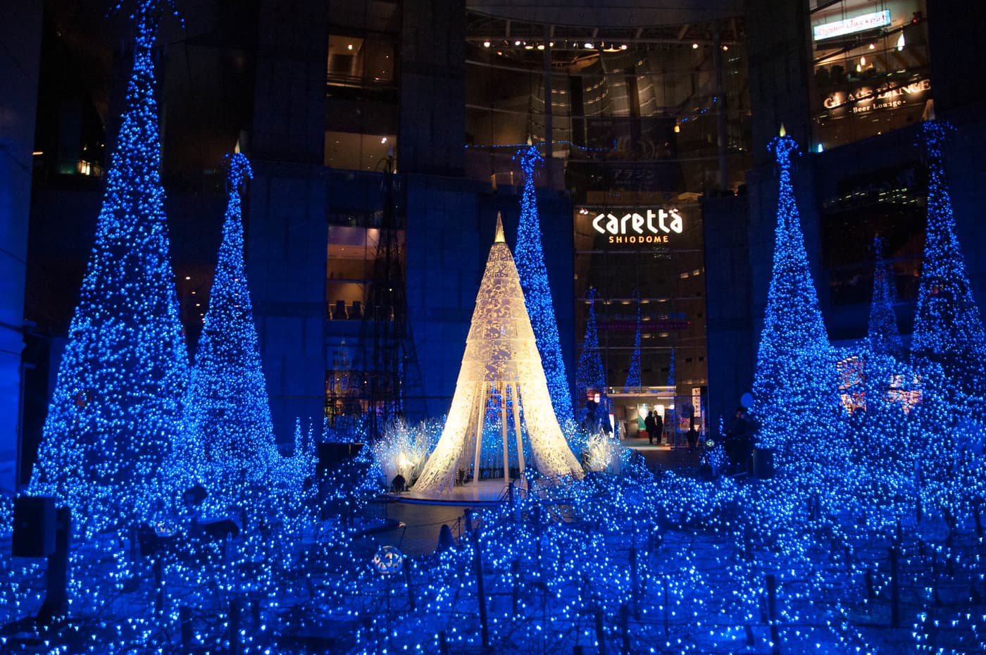 Blue light trees and cones filling the Caretta Shiodome plaza at Christmas