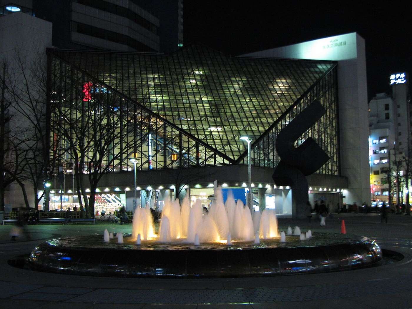 The fountain in Ikebukuro West Exit Park at night beside the Tokyo Metropolitan Theatre