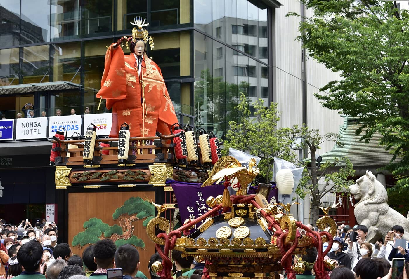 A decorated float topped with a warrior figure in the Kanda Matsuri Shinkosai procession