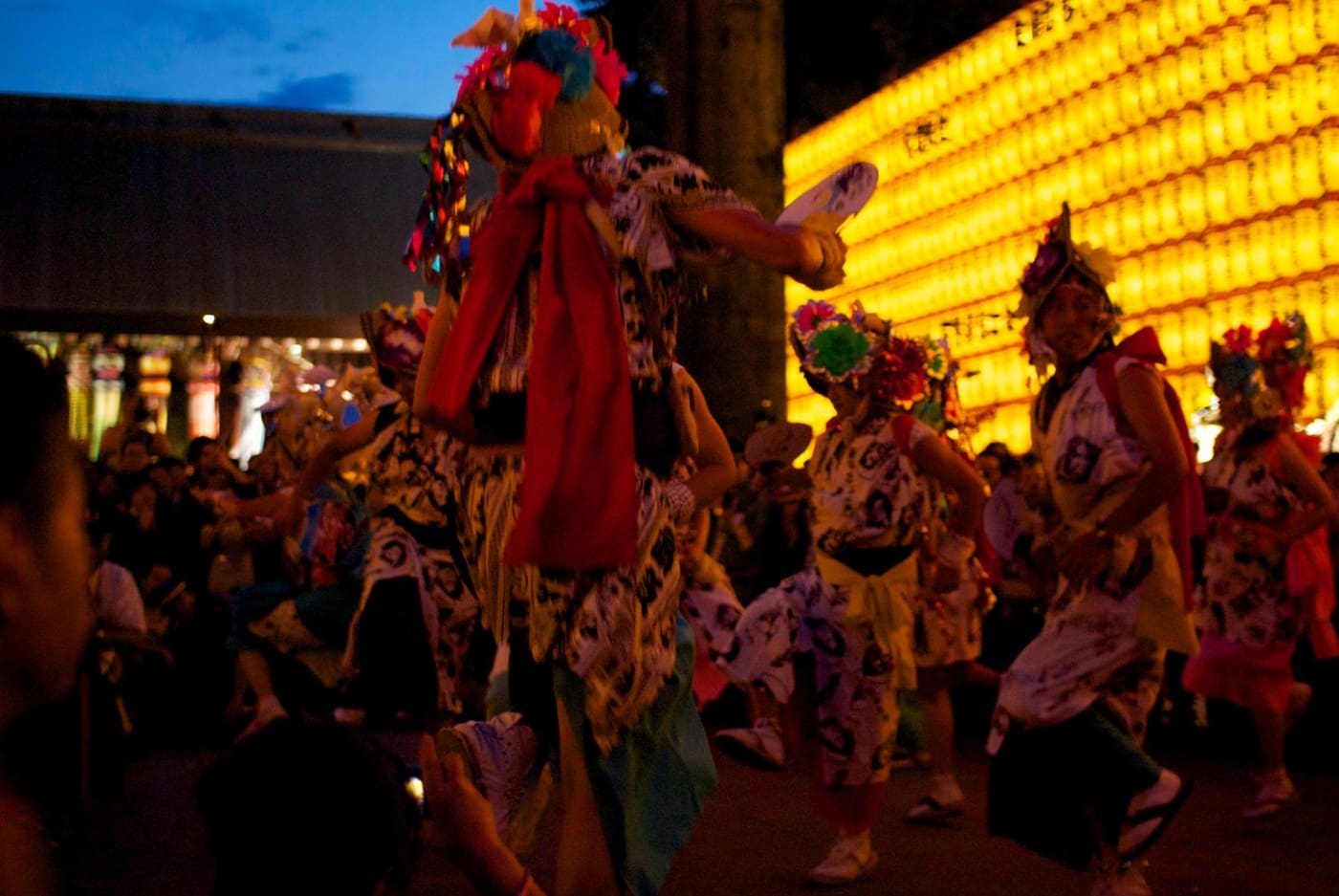 Costumed dancers performing in front of the lantern walls at Mitama Matsuri