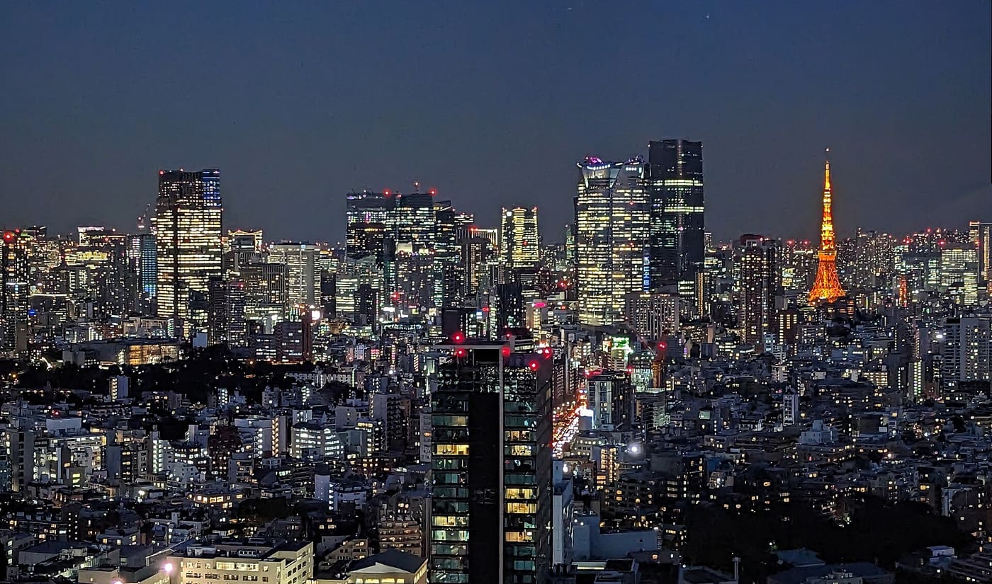 The Roppongi skyline and Tokyo Tower lit up at night seen from Shibuya
