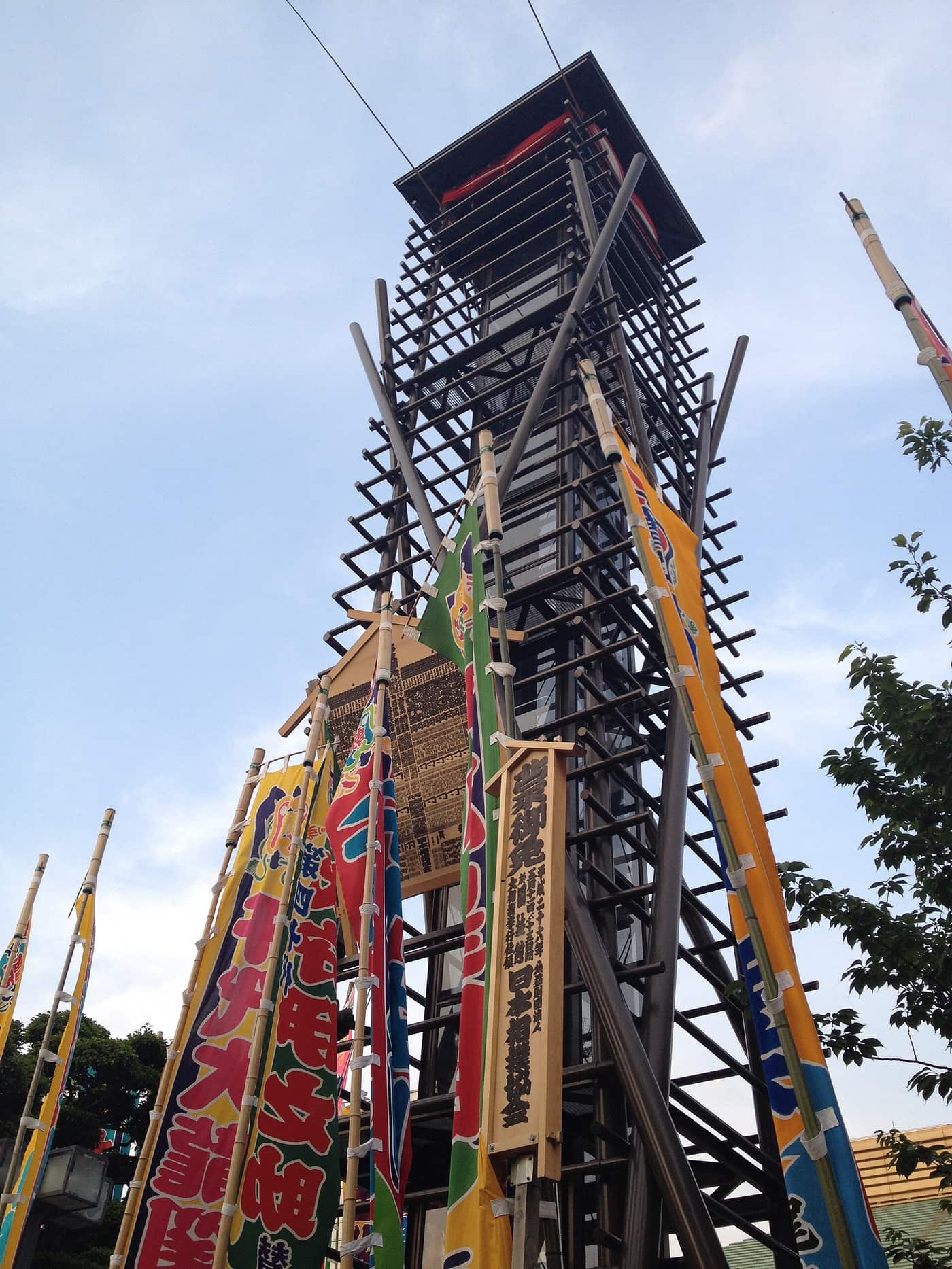 Colourful nobori banners and the drum tower outside Ryogoku Kokugikan during a tournament