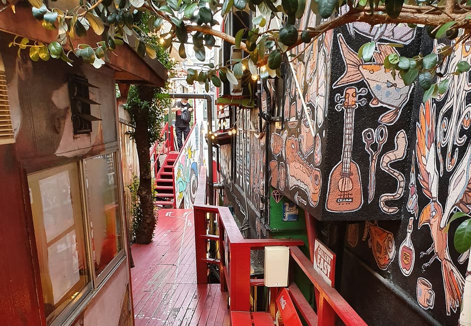 Red wooden stairway and graffiti-covered walls at Design Festa Gallery in Harajuku