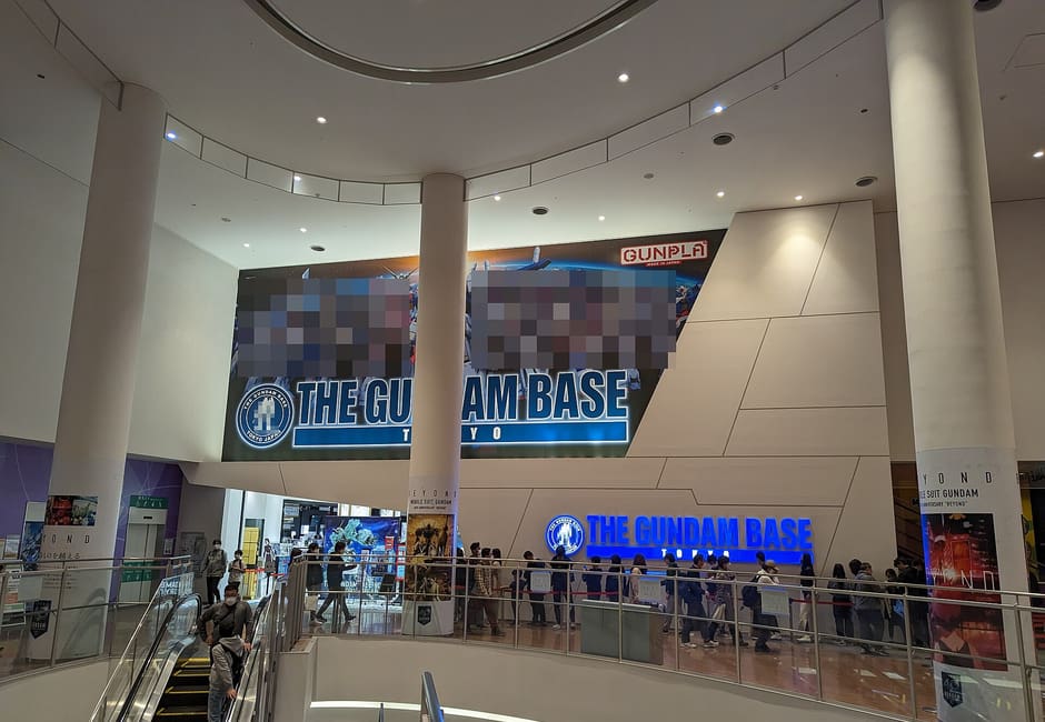 The entrance of The Gundam Base Tokyo inside DiverCity Tokyo Plaza, with its name sign above the shop