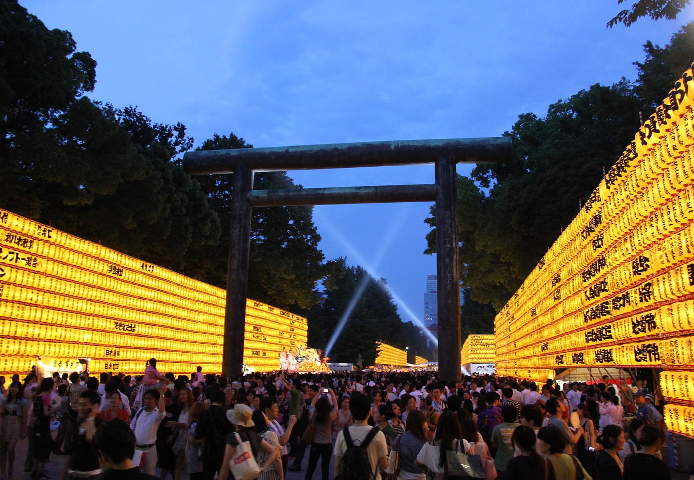 Walls of glowing paper lanterns lining the approach to Yasukuni Shrine during Mitama Matsuri