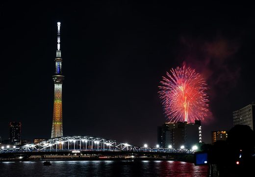 Fireworks bursting beside Tokyo Skytree above Azumabashi Bridge on the Sumida River