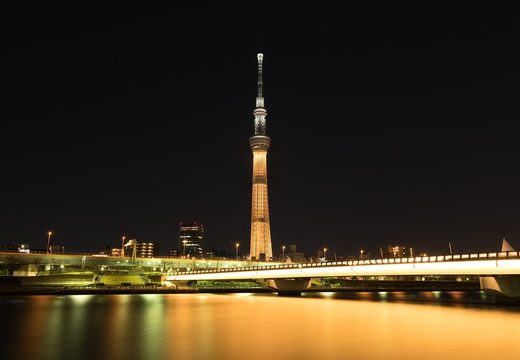 Tokyo Skytree lit up above the Sumida River at night