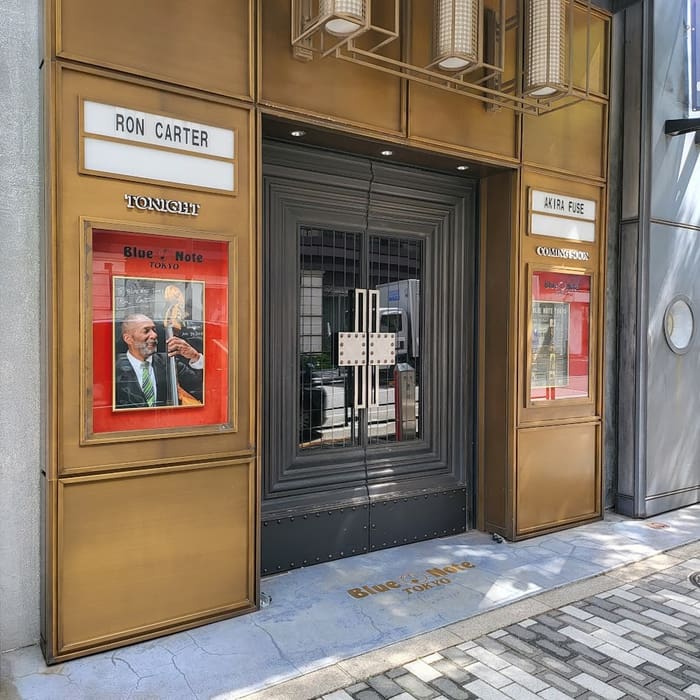 Gold entrance doors and marquee of Blue Note Tokyo on a Minami-Aoyama street