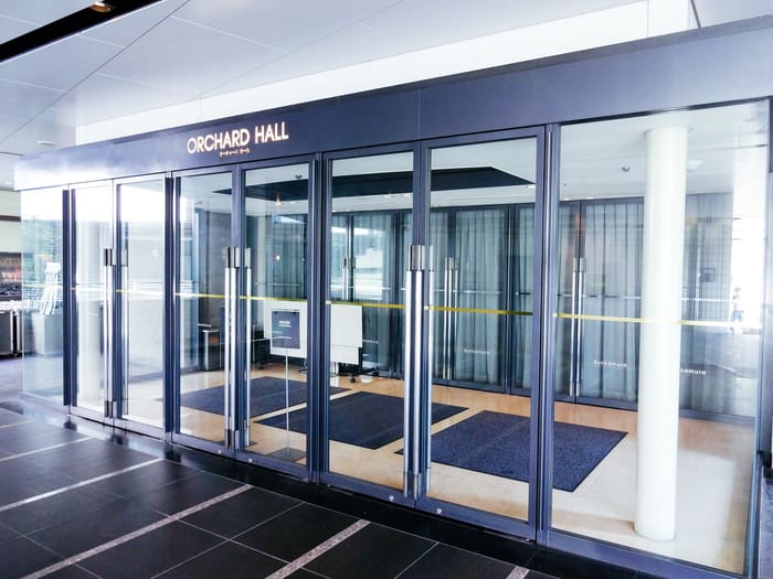 Glass entrance doors under the Orchard Hall sign inside Bunkamura, Shibuya