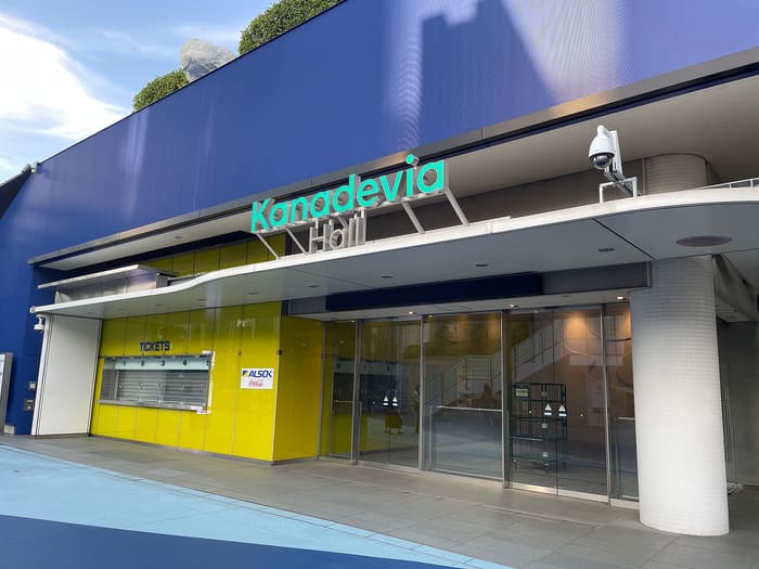 Kanadevia Hall's glass entrance and ticket windows under its sign at Tokyo Dome City