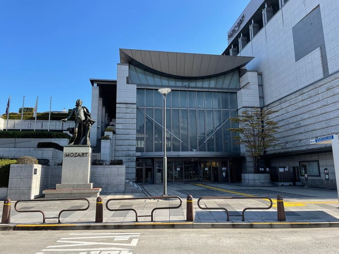 Glass entrance and Mozart statue in front of Katsushika Symphony Hills, Aoto