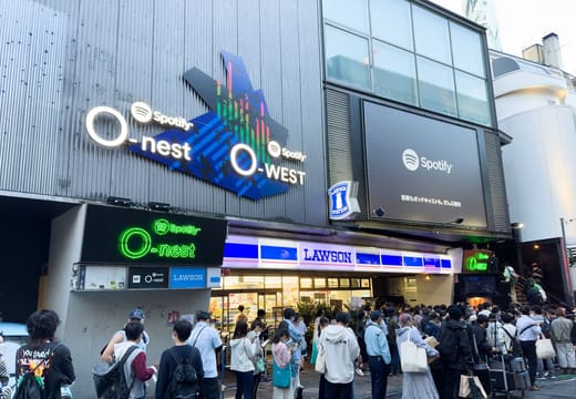 Spotify O-nest and O-WEST signs on their shared building on a Shibuya side street