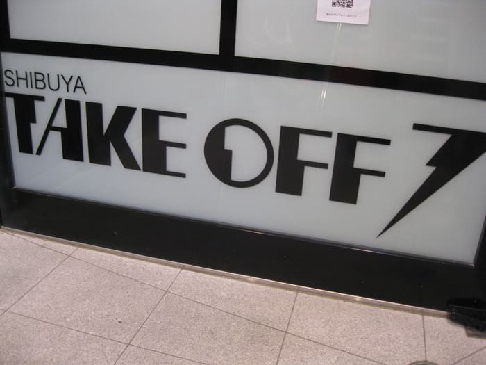 SHIBUYA TAKE OFF 7 logo on the glass at the live house entrance