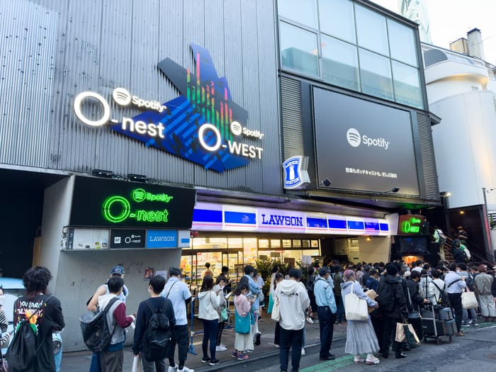 Spotify O-WEST and O-nest signs on their shared building on a Shibuya side street