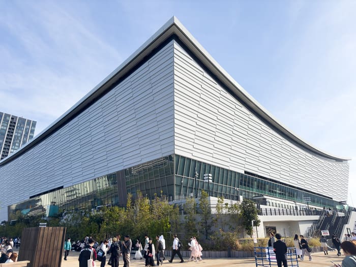 The curved silver facade of Tokyo Ariake Arena on the Ariake waterfront