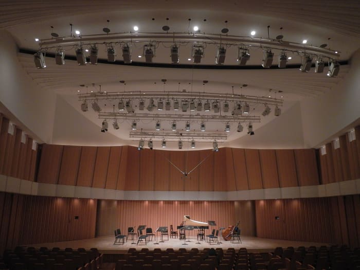 Empty stage and wood-panelled walls of the concert hall at Toppan Hall, Iidabashi