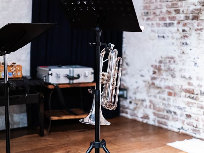 Brick-walled stage of live space ZIMAGINE in Aoyama set with music stands and a euphonium